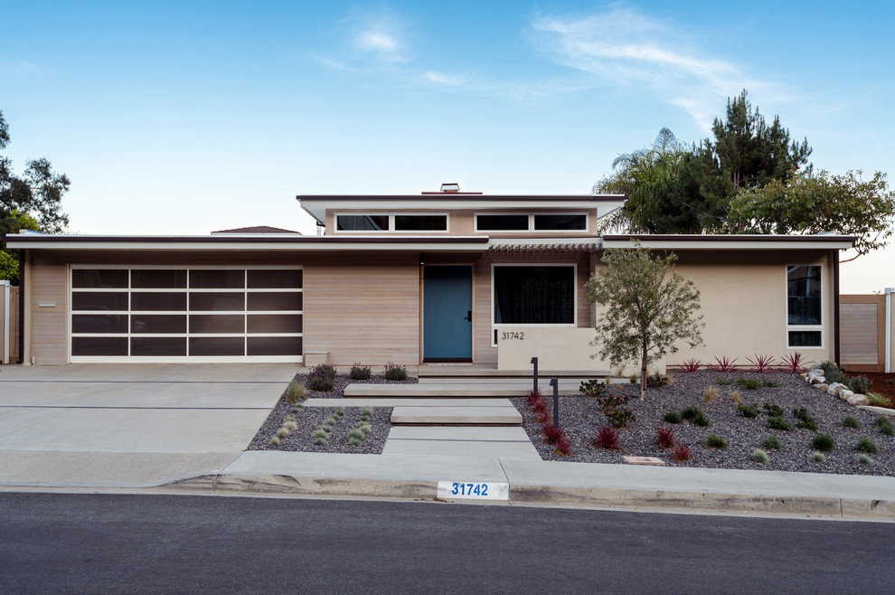 Mid-sized midcentury one-storey beige exterior in Orange County with wood siding.