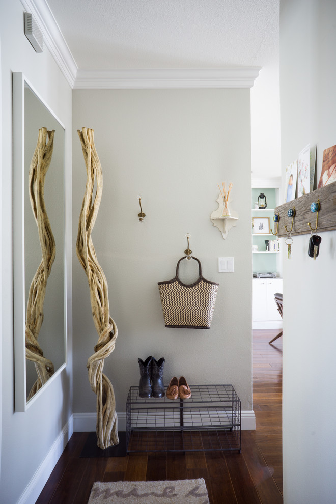 Photo of a small transitional entryway in San Francisco with beige walls and dark hardwood floors.