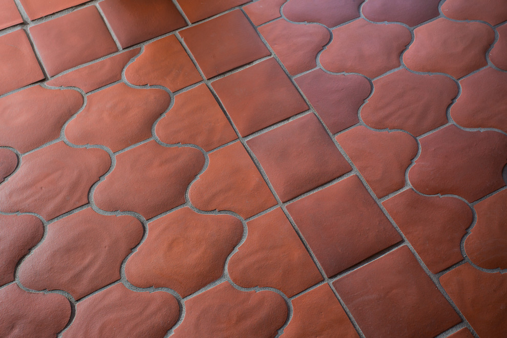 Design ideas for a large mediterranean courtyard patio in Los Angeles with a fire feature, tile and no cover.