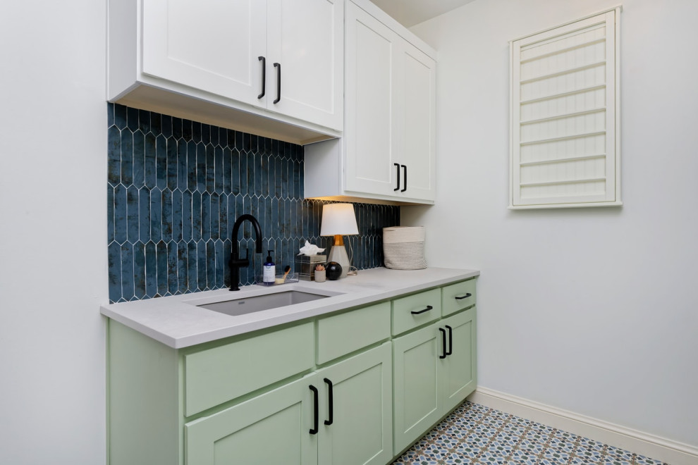 Large contemporary l-shaped dedicated laundry room in Santa Barbara with an undermount sink, shaker cabinets, white cabinets, white walls, ceramic floors and a side-by-side washer and dryer.