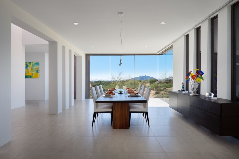 Photo of a large open plan dining in Phoenix with white walls, porcelain floors, no fireplace and beige floor.