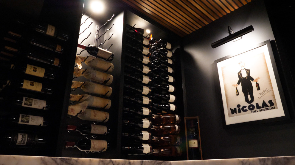 Small modern wine cellar in Brisbane with light hardwood floors.