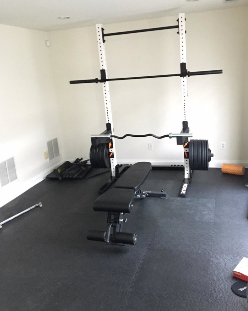 Inspiration for a small traditional home weight room in San Diego with white walls and black floor.