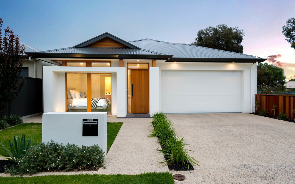 Contemporary one-storey stucco white house exterior in Adelaide with a hip roof and a metal roof.