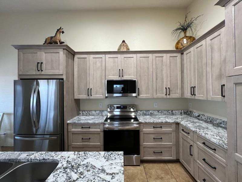 Inspiration for a mid-sized transitional l-shaped porcelain tile and brown floor eat-in kitchen remodel in Phoenix with an undermount sink, shaker cabinets, beige cabinets, granite countertops, gray backsplash, stone slab backsplash, stainless steel appliances, an island and gray countertops