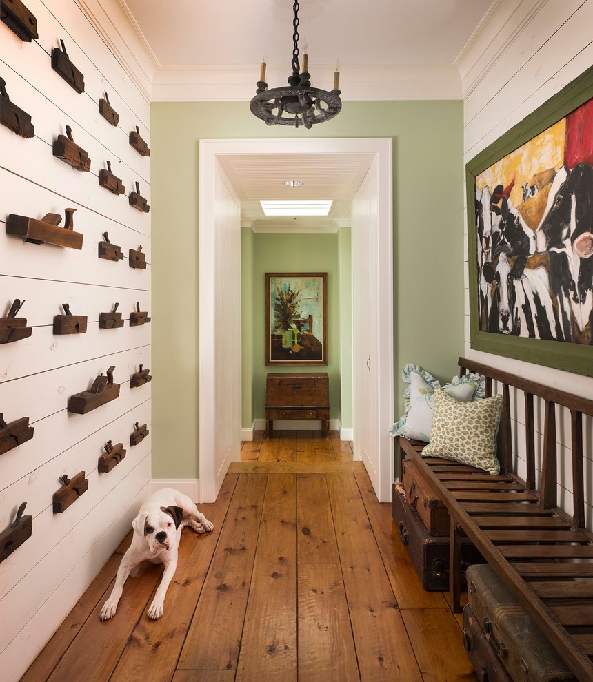 Inspiration for a country hallway in Dallas with green walls and medium hardwood floors.