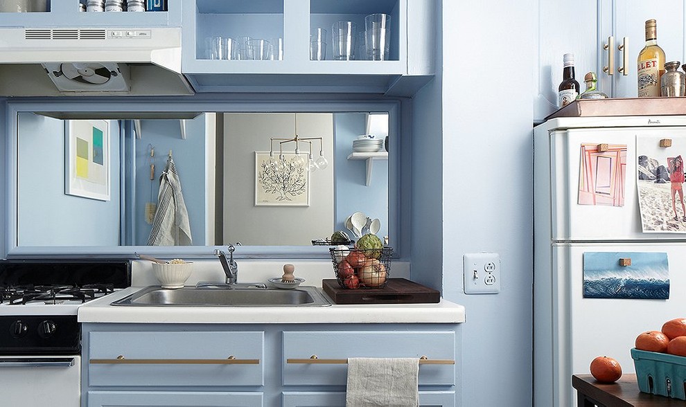 Design ideas for a small arts and crafts single-wall separate kitchen in New York with a drop-in sink, shaker cabinets, blue cabinets, laminate benchtops, metallic splashback, mirror splashback, white appliances and no island.