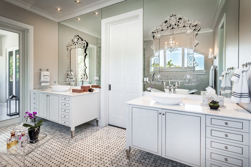 Inspiration for a large traditional master bathroom in Miami with a vessel sink, white cabinets, quartzite benchtops, a freestanding tub, an open shower, a one-piece toilet, stone tile, grey walls, marble floors, white tile and flat-panel cabinets.