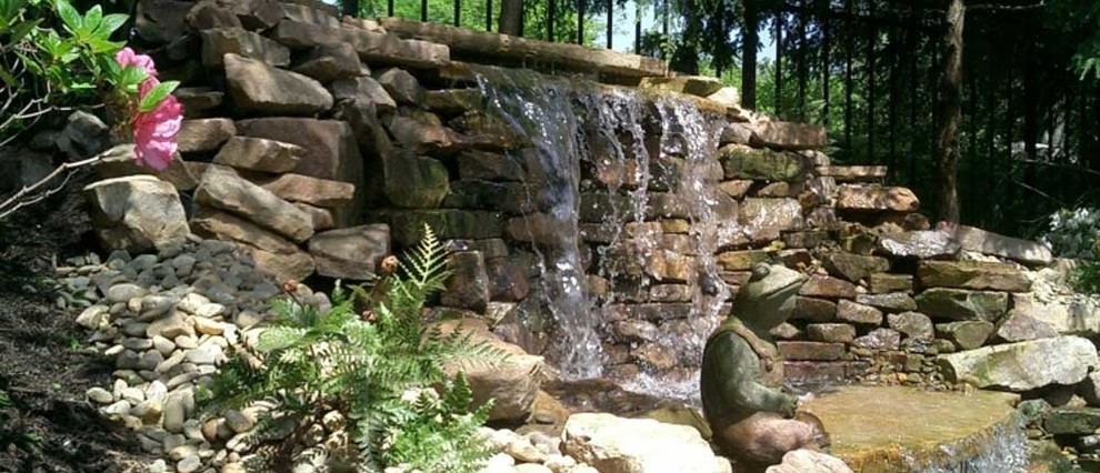 Photo of a large partial sun backyard water fountain landscape.