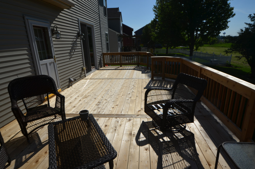 Example of a mid-sized classic backyard deck design with no cover