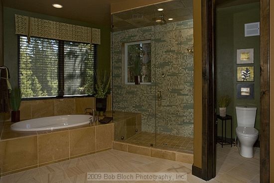 Inspiration for an expansive modern master bathroom in Denver with green walls, travertine floors, a vessel sink, flat-panel cabinets, dark wood cabinets, onyx benchtops, a drop-in tub, a corner shower, a one-piece toilet, multi-coloured tile and glass tile.