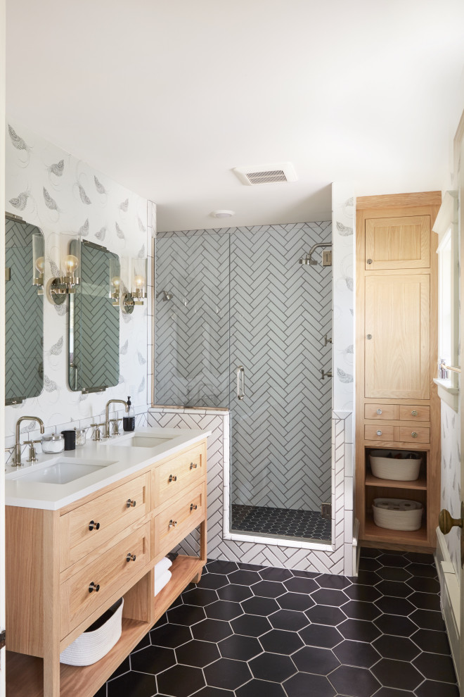 Inspiration for a large transitional master bathroom in Minneapolis with light wood cabinets, an alcove shower, white tile, ceramic tile, white walls, ceramic floors, black floor, a hinged shower door, white benchtops, shaker cabinets, an undermount sink, a double vanity, a freestanding vanity and wallpaper.