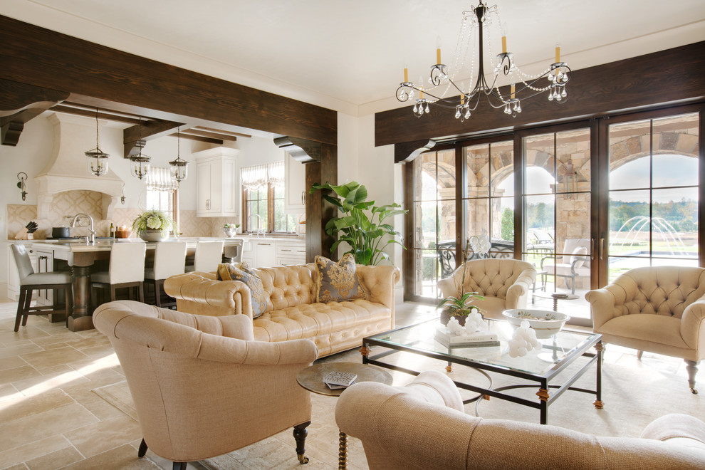 Photo of a large mediterranean open concept living room in Other with beige walls, limestone floors, a standard fireplace, a stone fireplace surround and a wall-mounted tv.