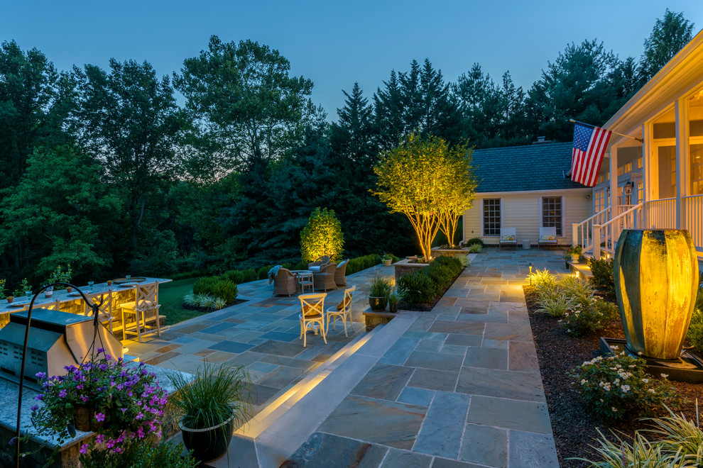 Design ideas for a mid-sized traditional backyard patio in DC Metro with a fire feature and natural stone pavers.