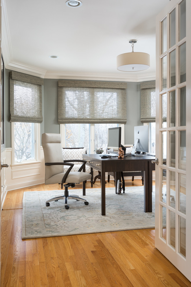Inspiration for a mid-sized transitional freestanding desk light wood floor and brown floor study room remodel in Chicago with gray walls and no fireplace