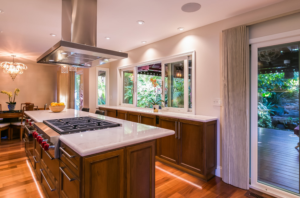 Large contemporary galley eat-in kitchen in San Francisco with an undermount sink, recessed-panel cabinets, dark wood cabinets, quartz benchtops, white splashback, stone slab splashback, stainless steel appliances, with island, brown floor, medium hardwood floors and white benchtop.