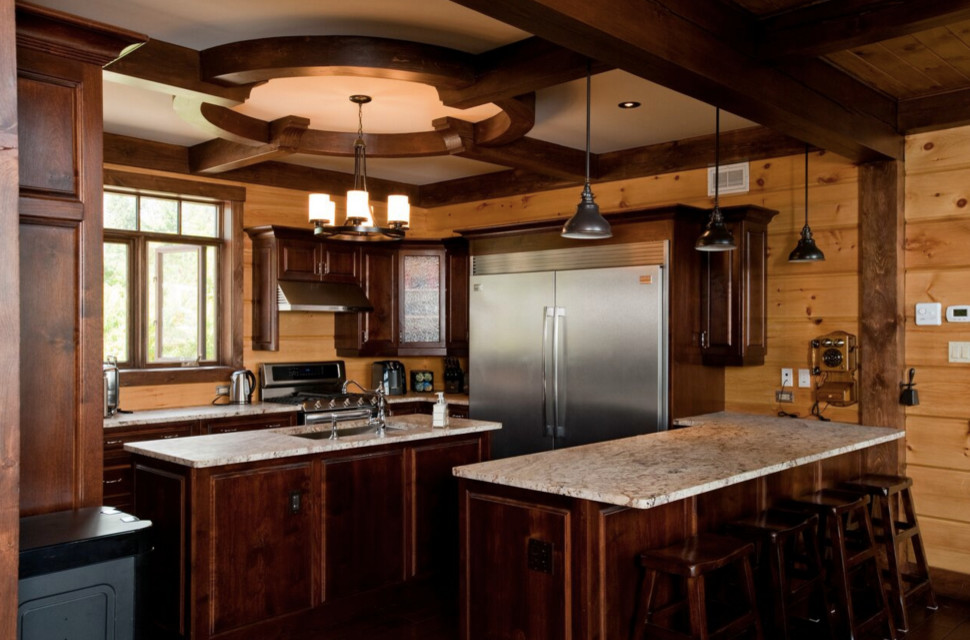 Open concept kitchen - large rustic galley light wood floor open concept kitchen idea in Boston with an undermount sink, shaker cabinets, dark wood cabinets, granite countertops, stainless steel appliances and an island