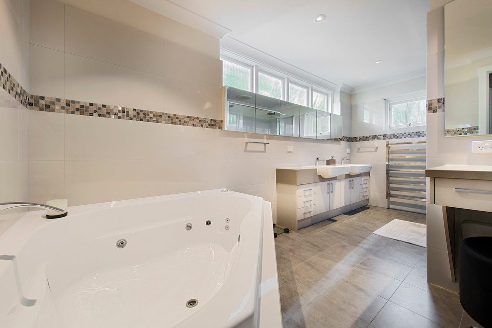 Photo of a mid-sized modern master bathroom in Perth with beige cabinets, a corner tub, white tile, mosaic tile and white walls.