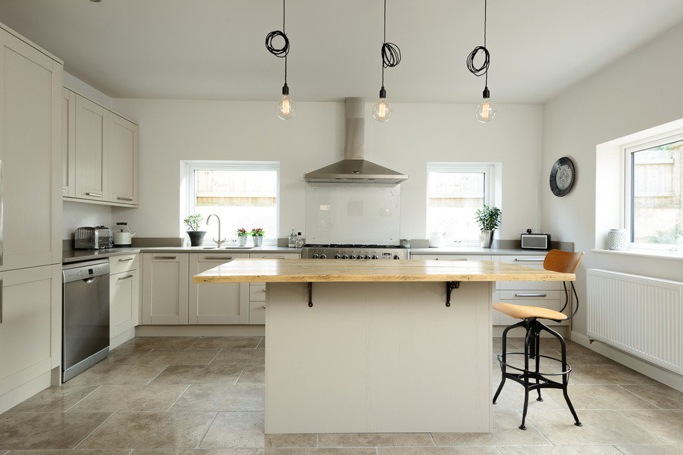 Inspiration for a large transitional l-shaped kitchen in Other with shaker cabinets, grey cabinets, solid surface benchtops, glass sheet splashback, stainless steel appliances, limestone floors and with island.