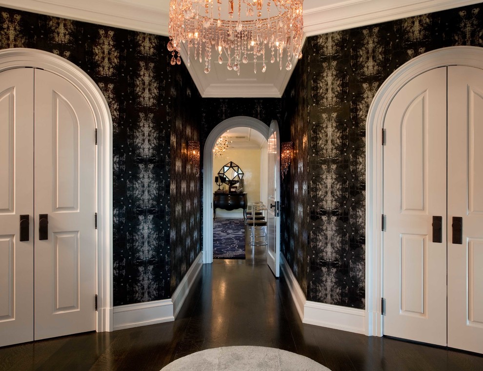 Photo of an expansive contemporary hallway in New York with black walls and dark hardwood floors.