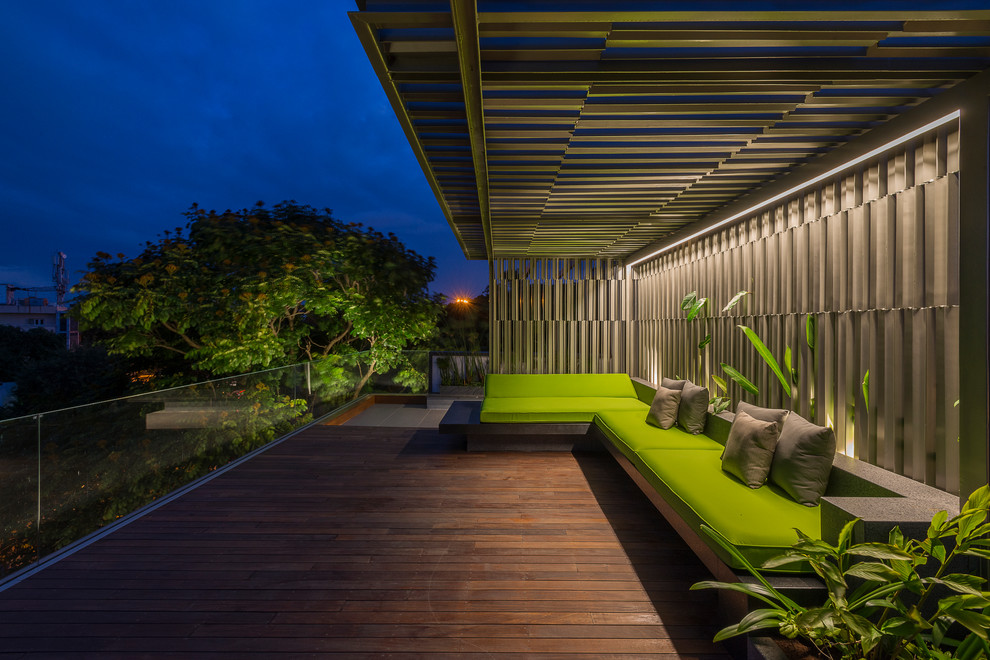 This is an example of a contemporary deck in Bengaluru with a pergola.