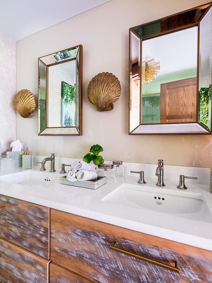 Inspiration for a small eclectic bathroom with distressed cabinets, beige tile, glass sheet wall, beige walls, solid surface benchtops, white benchtops, an undermount sink and flat-panel cabinets.