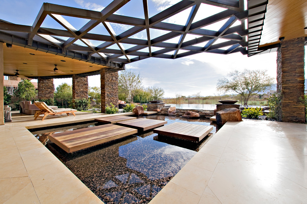 Photo of a contemporary backyard custom-shaped infinity pool in Las Vegas with tile.