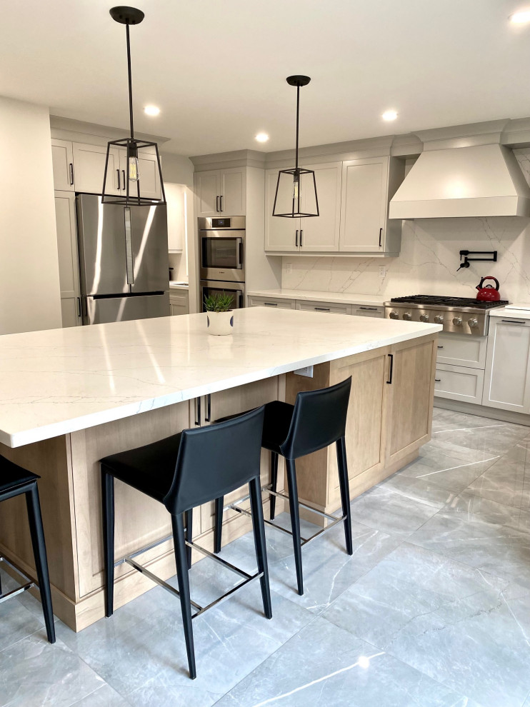 Inspiration for a mid-sized transitional l-shaped porcelain tile open concept kitchen remodel in Toronto with an undermount sink, shaker cabinets, gray cabinets, quartz countertops, white backsplash, quartz backsplash, stainless steel appliances, an island and white countertops
