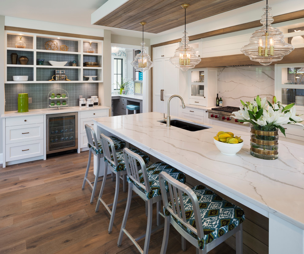Large transitional l-shaped eat-in kitchen in Minneapolis with an undermount sink, white cabinets, white splashback, stainless steel appliances, with island, shaker cabinets, marble benchtops, dark hardwood floors and marble splashback.