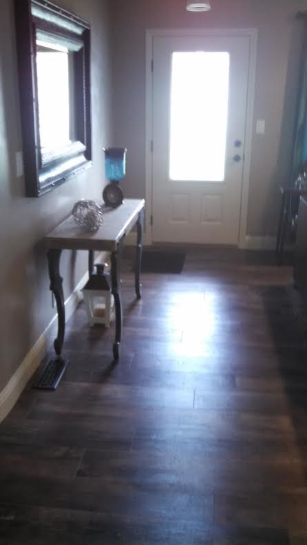 Inspiration for a mid-sized vinyl floor entryway remodel