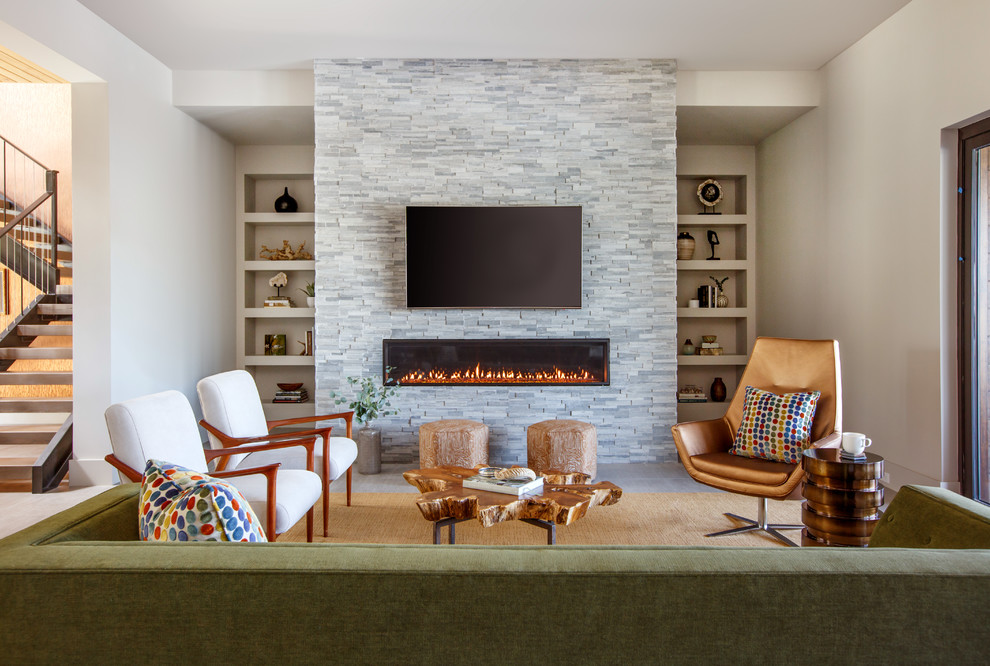 Photo of a large contemporary enclosed living room in Jacksonville with grey walls, porcelain floors, a ribbon fireplace, a stone fireplace surround, a wall-mounted tv and grey floor.