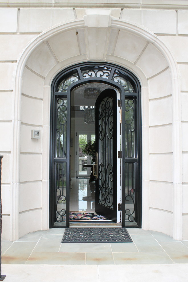 This is an example of a large traditional front door in New York with white walls, a single front door and a metal front door.
