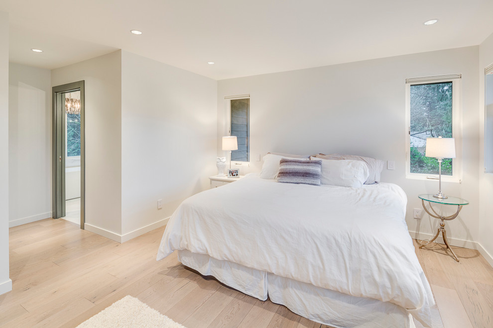 Inspiration for a large transitional master light wood floor and beige floor bedroom remodel in Vancouver with white walls and no fireplace