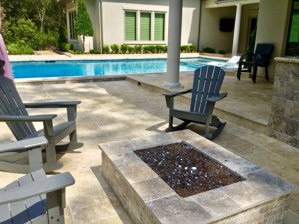 Large transitional backyard rectangular lap pool in Houston with a water feature and natural stone pavers.