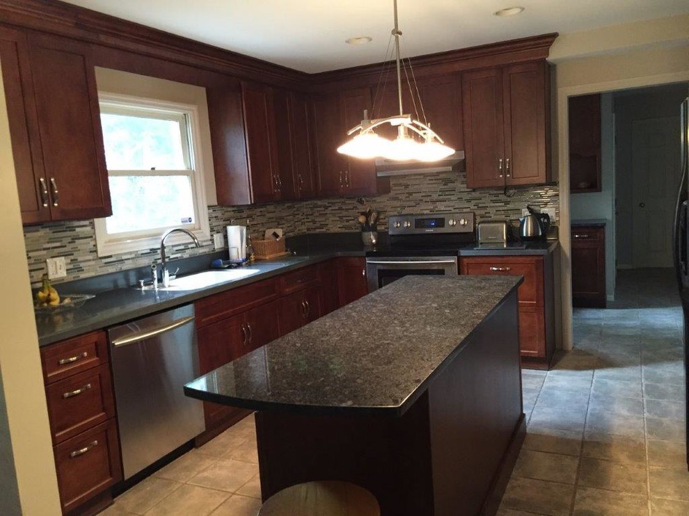 Eat-in kitchen - mid-sized transitional l-shaped porcelain tile eat-in kitchen idea in Cincinnati with an undermount sink, shaker cabinets, granite countertops, multicolored backsplash, glass tile backsplash, stainless steel appliances, an island and dark wood cabinets