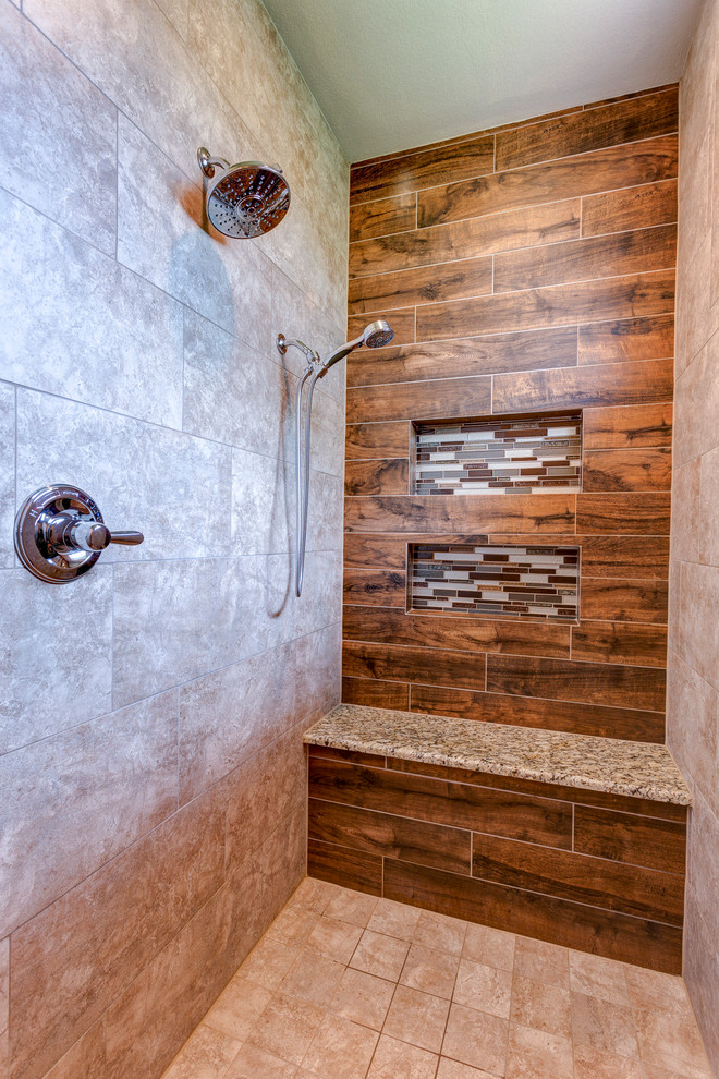 Large country master bathroom in Austin with raised-panel cabinets, dark wood cabinets, a drop-in tub, a corner shower, ceramic tile, beige walls, ceramic floors, an undermount sink, granite benchtops, beige floor, a hinged shower door and multi-coloured benchtops.