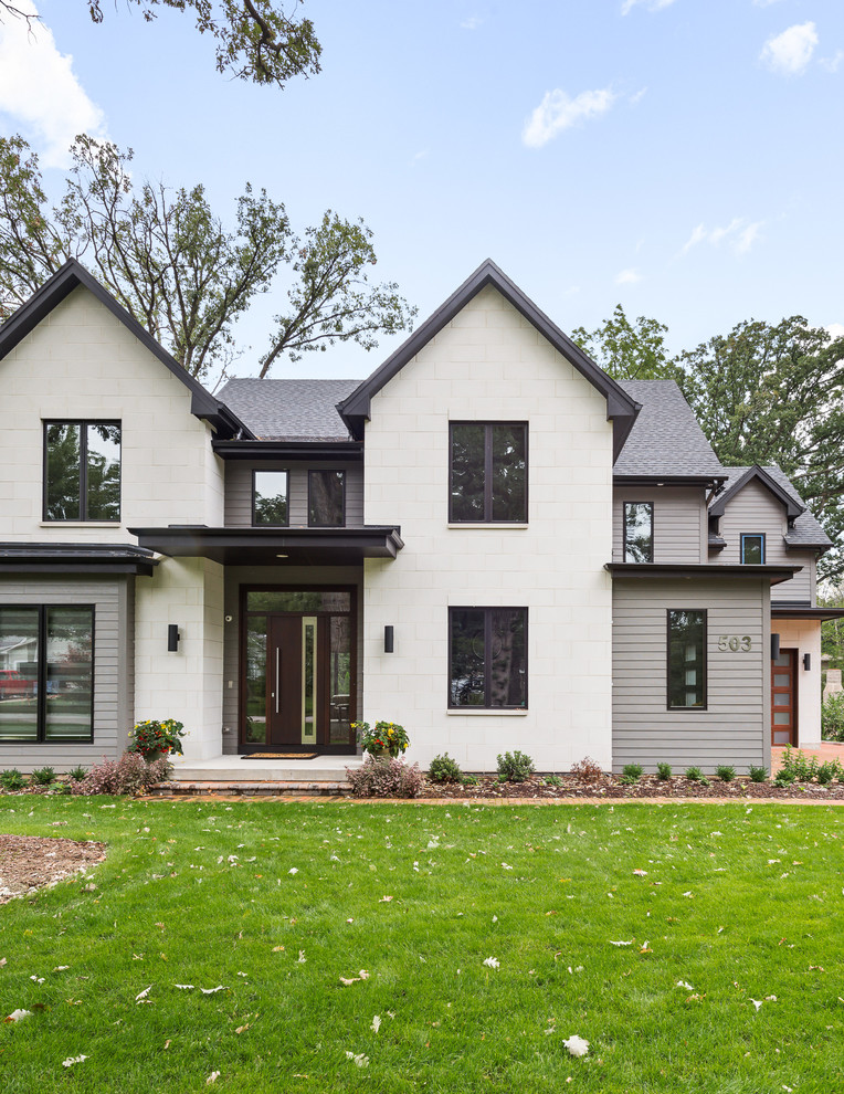 Large contemporary two-storey white house exterior in Chicago with stone veneer, a hip roof and a green roof.
