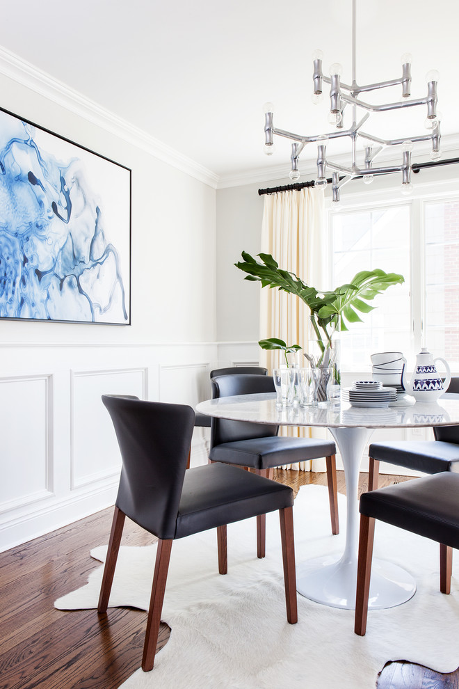 Inspiration for a transitional dining room in New York with white walls, dark hardwood floors and brown floor.