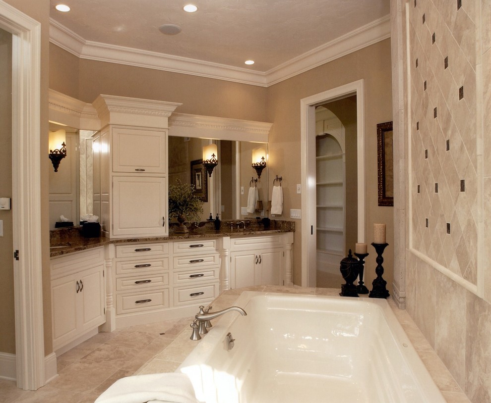 Photo of a mid-sized traditional master bathroom in Other with an undermount sink, beaded inset cabinets, white cabinets, granite benchtops, a drop-in tub, beige tile, ceramic tile, beige walls and porcelain floors.