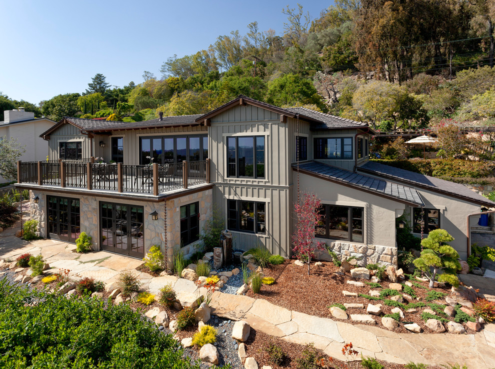 Photo of a mid-sized asian two-storey grey exterior in Santa Barbara with concrete fiberboard siding.