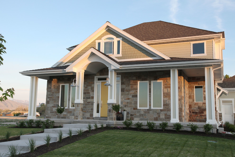 Photo of a mid-sized arts and crafts three-storey green exterior in Salt Lake City with mixed siding.