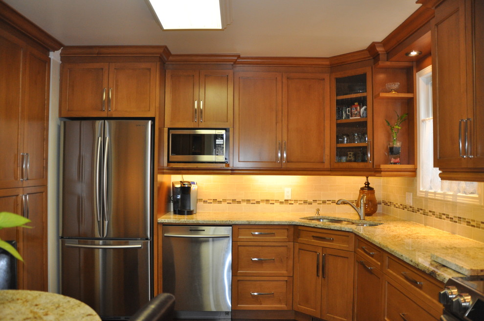 Example of a small l-shaped ceramic tile enclosed kitchen design in Ottawa with an undermount sink, shaker cabinets, medium tone wood cabinets, granite countertops, beige backsplash, ceramic backsplash, stainless steel appliances and no island