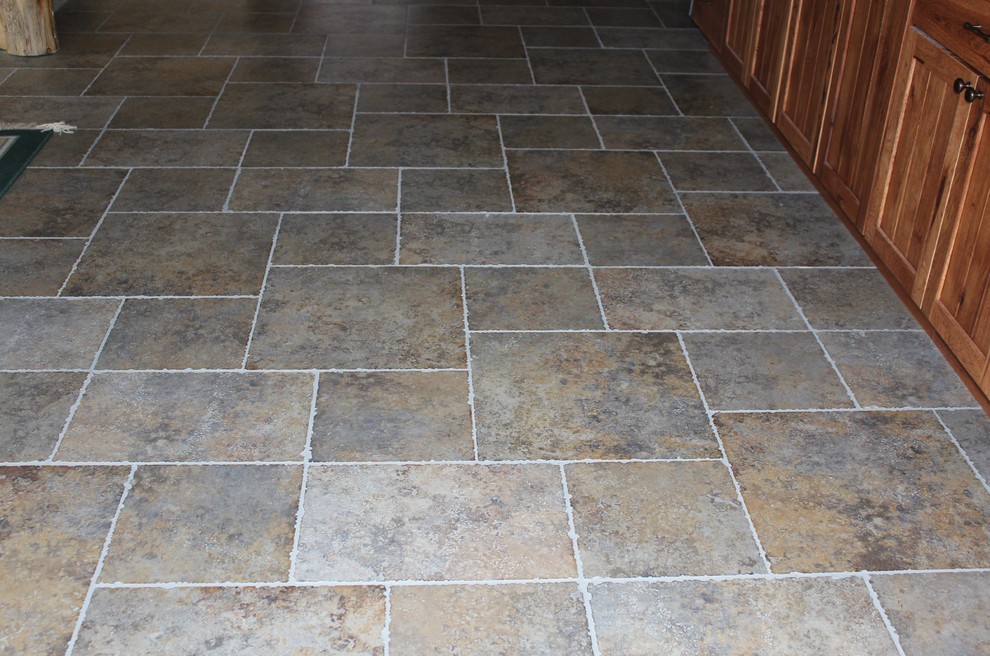 Example of a mountain style ceramic tile and gray floor kitchen design with recessed-panel cabinets and medium tone wood cabinets
