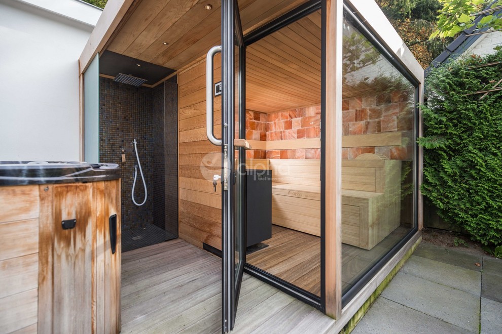 Inspiration for a mid-sized modern backyard deck in Los Angeles with an outdoor shower and a roof extension.