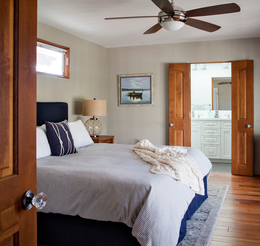 Large beach style master bedroom in San Francisco with beige walls, bamboo floors and no fireplace.