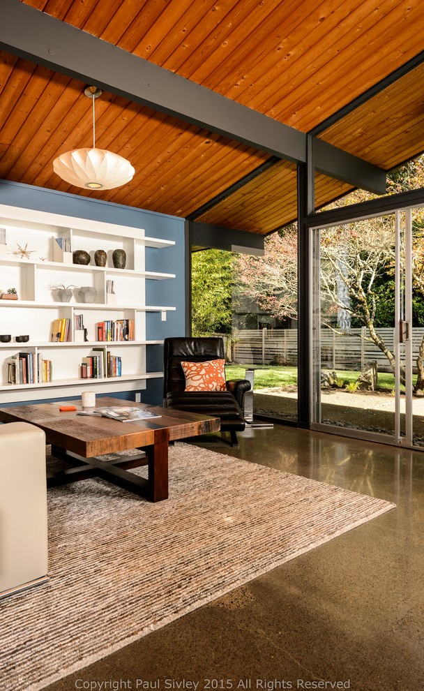This is an example of a mid-sized midcentury open concept living room in Portland with blue walls.