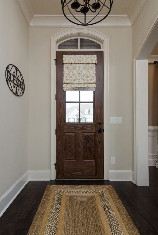 Small traditional front door in Atlanta with beige walls, dark hardwood floors, a single front door, a dark wood front door and brown floor.