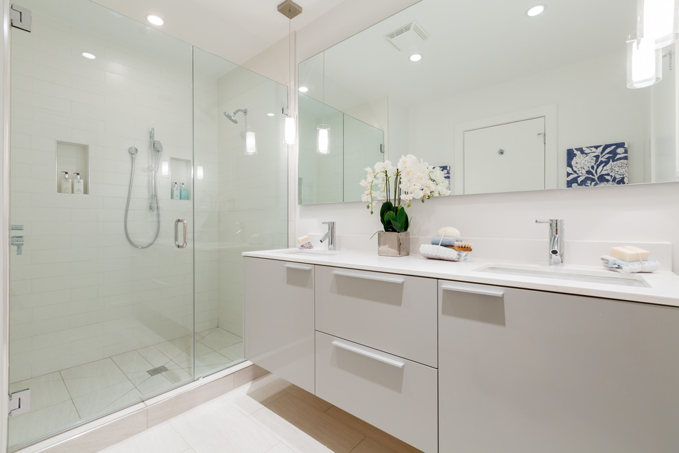 Example of a trendy white tile and subway tile alcove shower design in DC Metro with an undermount sink, flat-panel cabinets, white cabinets and white countertops