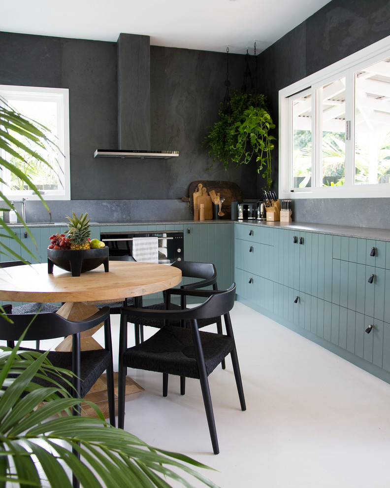 Photo of a mid-sized contemporary l-shaped eat-in kitchen in Sydney with an undermount sink, flat-panel cabinets, green cabinets, quartz benchtops, grey splashback, slate splashback, stainless steel appliances, painted wood floors, white floor and grey benchtop.
