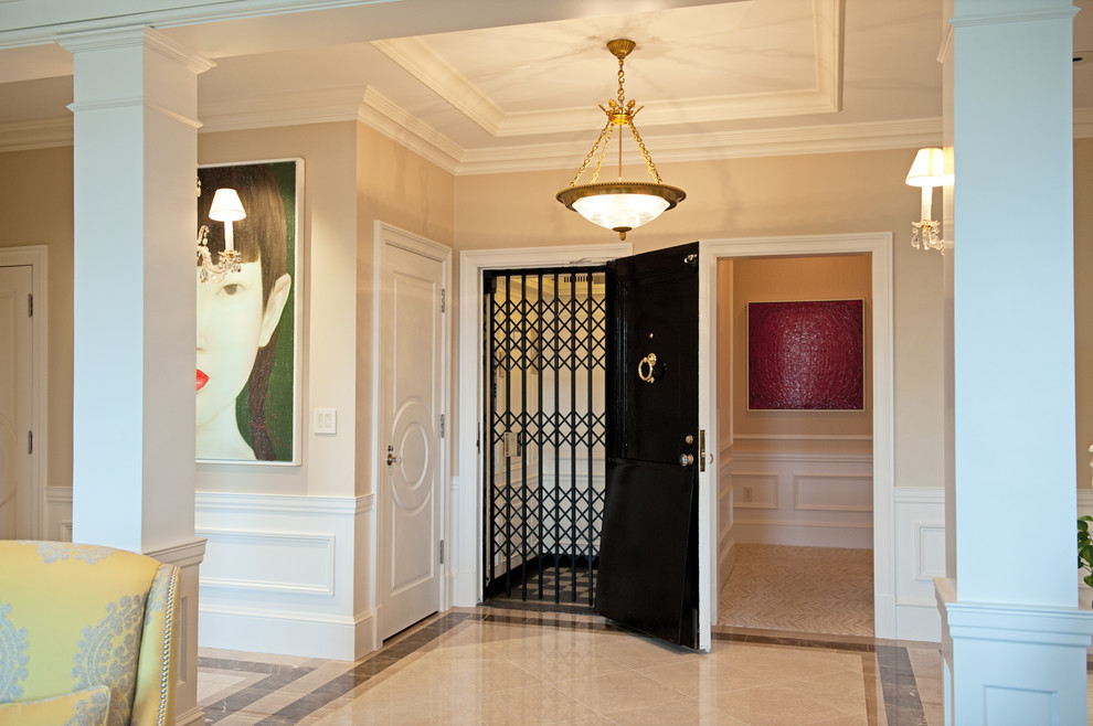 Design ideas for a contemporary entryway in Boston with beige walls and marble floors.